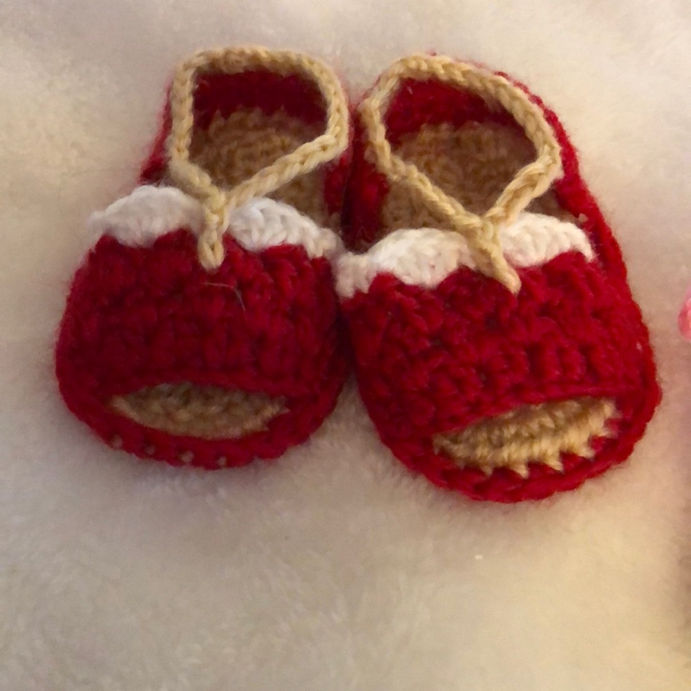 Two sets of knitted baby shoes